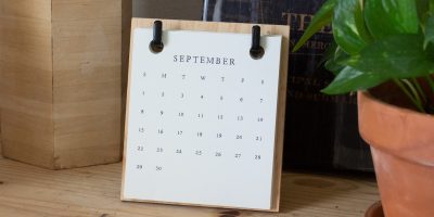 white braille paper on brown wooden table